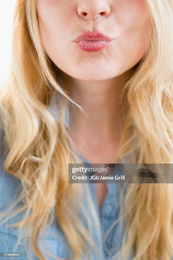 Caucasian woman blowing a kiss