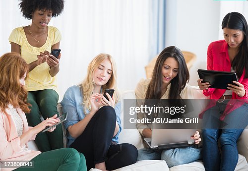 Ladies Using Technology Women Using Technology On Sofa High-Res Stock Photo - Getty Images
