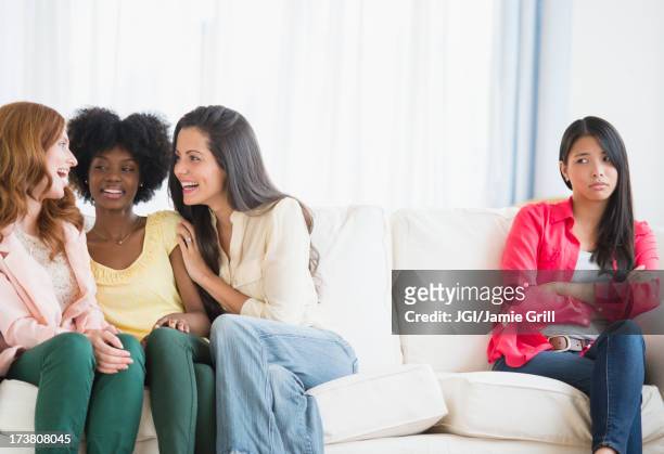 woman excluded from conversation on sofa - social exclusion stock pictures, royalty-free photos & images