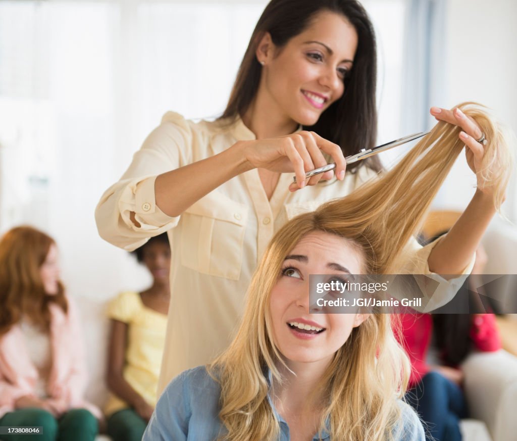 Worried woman having her hair cut