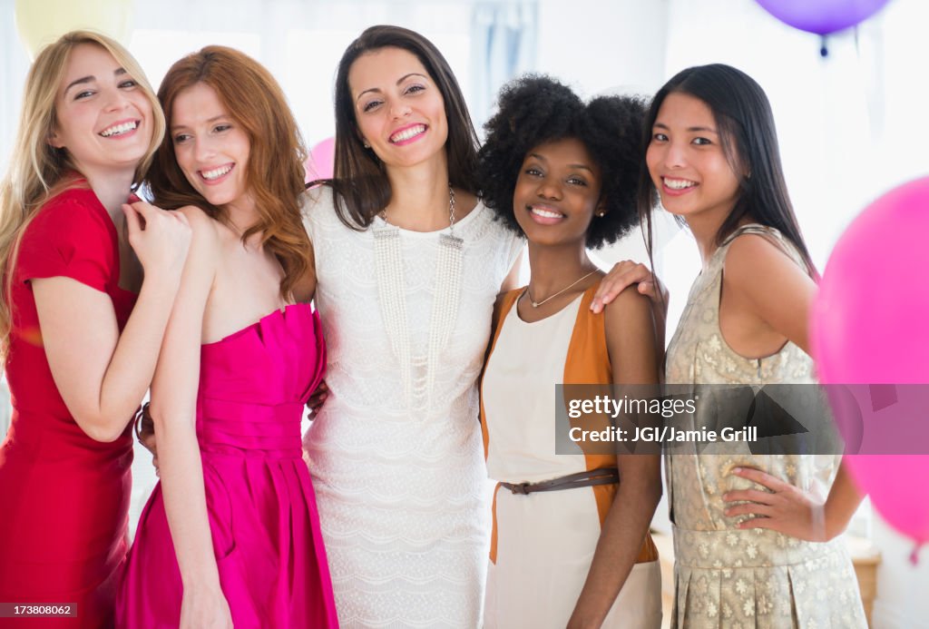Smiling women standing together at party