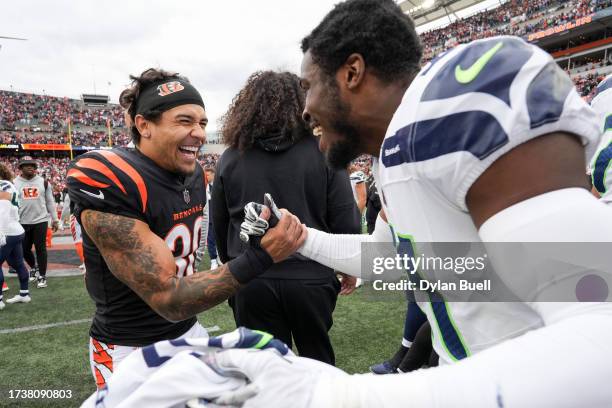 Chase Brown of the Cincinnati Bengals and Devon Witherspoon of the Seattle Seahawks meet after the Bengals beat the Seahawks 17-13 at Paycor Stadium...