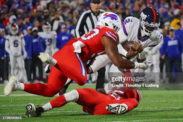 Tyrod Taylor of the New York Giants is tacked by Greg Rousseau of the Buffalo Bills in the first quarter of a game at Highmark Stadium on October 15,...