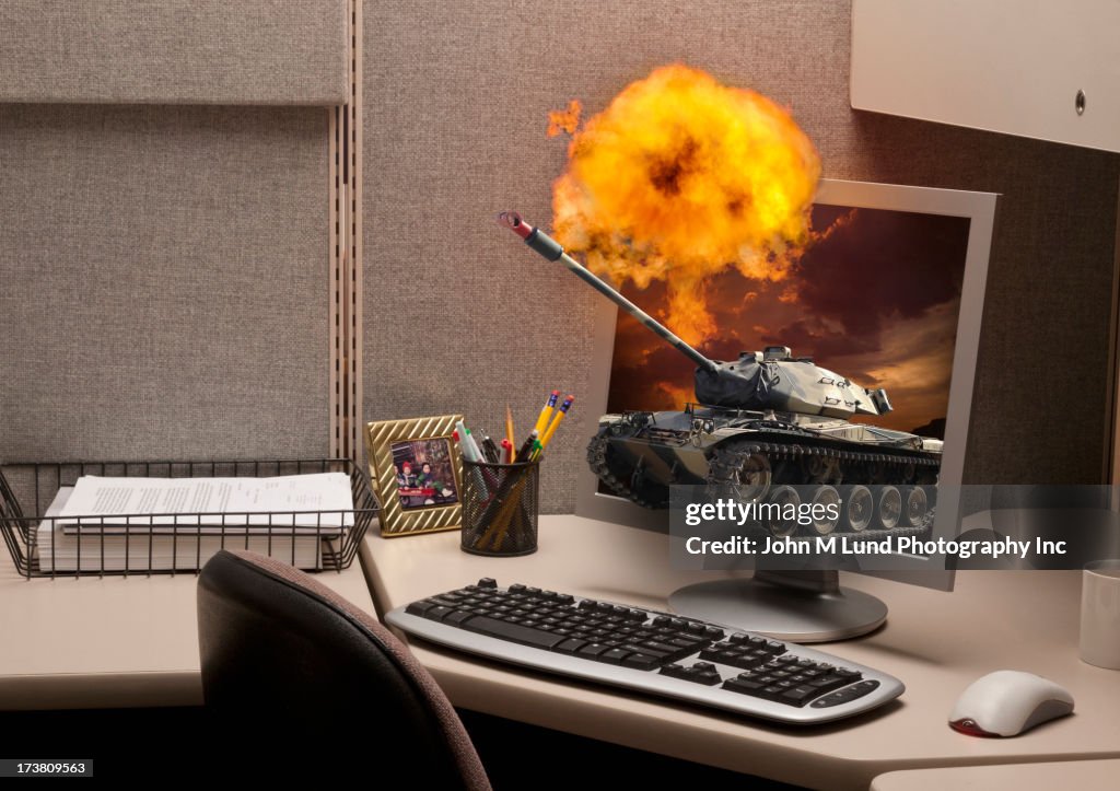 Tank Emerging From Computer Screen In Cubicle High-Res Stock Photo ...