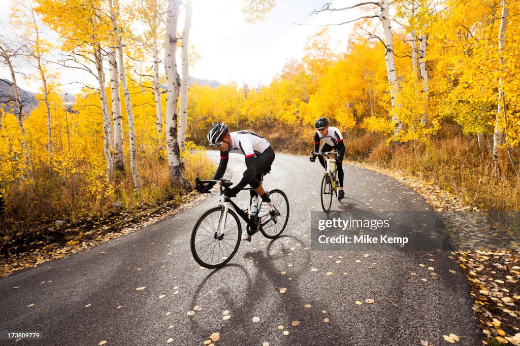 Caucasian cyclists on rural road