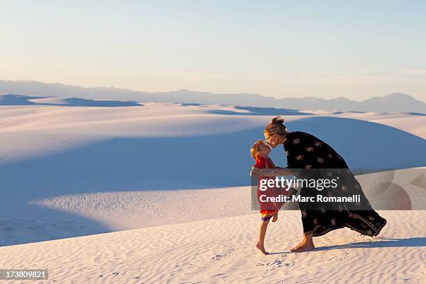 caucasian mother and daughter kissing in desert - kids fashion stock pictures, royalty-free photos & images