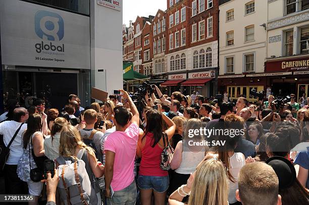 Miley Cyrus is hounded by photographers and fans outside the Capital radio studios in Leicester square on July 18, 2013 in London, England.