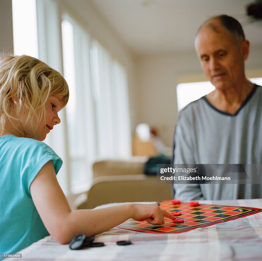 Grandfather and Granddaughter playing Checkers