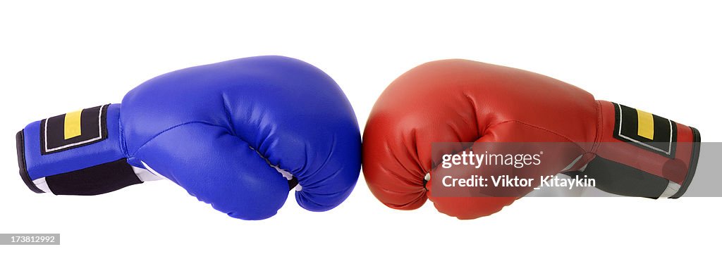 Red and blue boxing gloves with a white backdrop