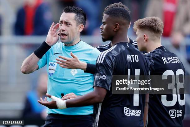 Referee Dennis Higler in discussion with Jorrel Hato of Ajax, Benjamin Tahirovic of Ajax, Kristian Hlynsson of Ajax during the Dutch Eredivisie match...