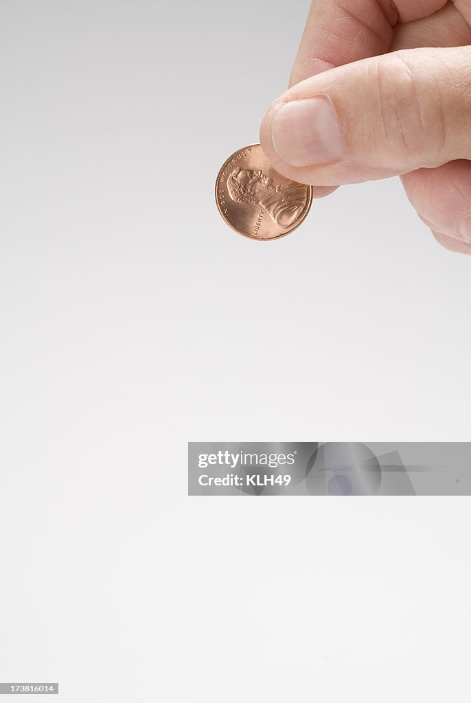 Penny and human hand