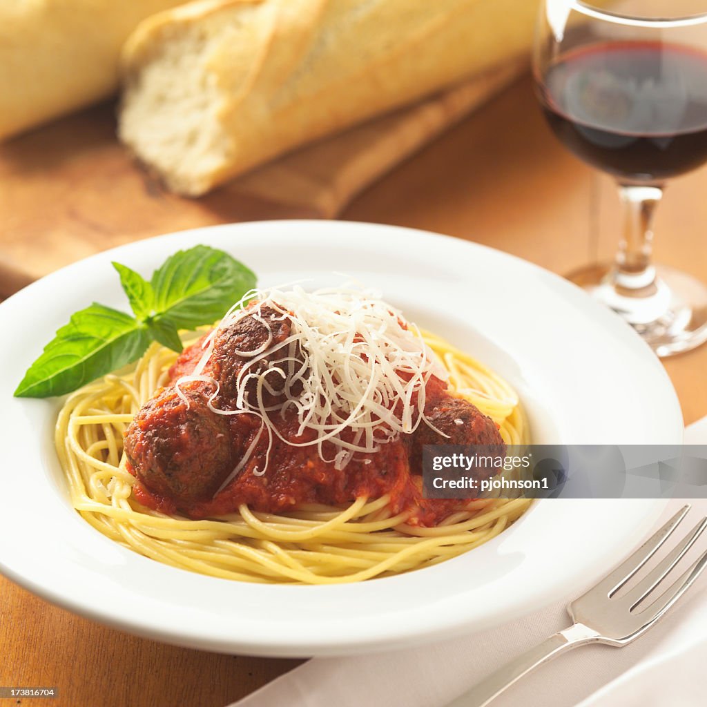 White dish holding spaghetti and meatballs