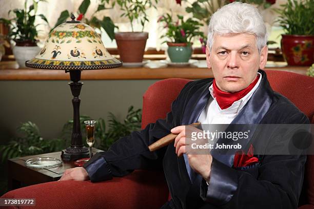 millionaire at home with smoking jacket, cigar, and intense look - smoking jacket 個照片及圖片檔