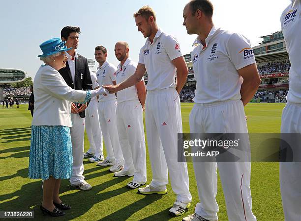Britain's Queen Elizabeth II shakes hands with England's Stuart Broad as she meets English and Australian cricketers before the start of the first...
