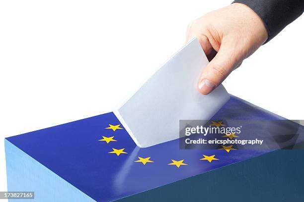 male hand inserting ballot to eu ballot box - campaign stockfoto's en -beelden