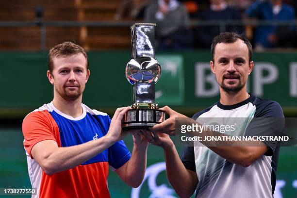 Kazakstan's Andrey Golubev and Ukraine's Denys Molchanov celebrate with the trophy after winning the doubles final match against India's Yuki Bhambri...