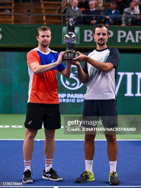 Kazakstan's Andrey Golubev and Ukraine's Denys Molchanov celebrate with the trophy after winning the doubles final match against India's Yuki Bhambri...