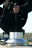 close up of a chimney sweep on the roof