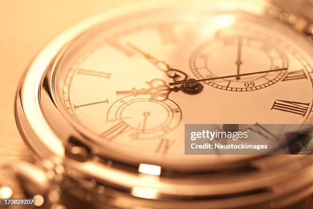 cropped image of pocket watch - antique watch stock pictures, royalty-free photos & images