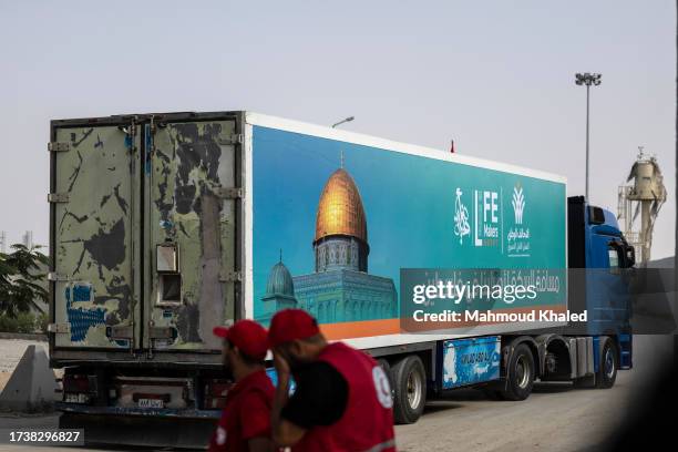 The second convoy of aid trucks cross the Rafah border from the Egyptian side on October 22, 2023 in North Sinai, Egypt. The aid convoy, organized by...