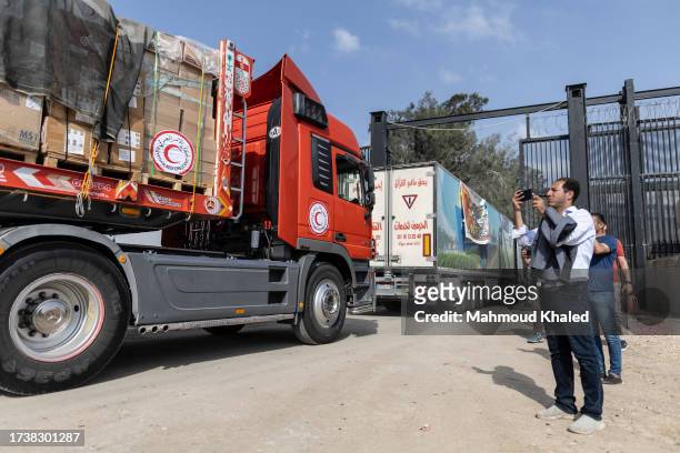 The second convoy of aid trucks cross the Rafah border from the Egyptian side on October 22, 2023 in North Sinai, Egypt. The aid convoy, organized by...