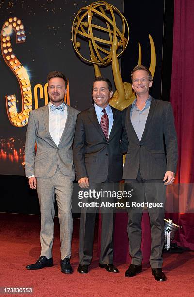 Actor Aaron Paul, Academy of Television Arts & Sciences Chairman & CEO Bruce Rosenblum and actor Neil Patrick Harris pose onstage following the 65th...