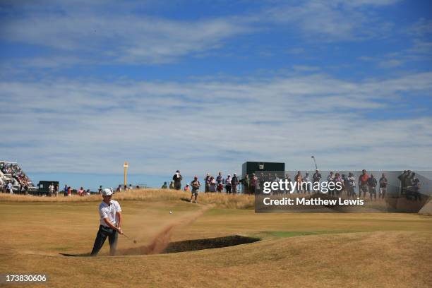 Zach Johnson of the United States hits out of a bunker on the 14th hole during the first round of the 142nd Open Championship at Muirfield on July...