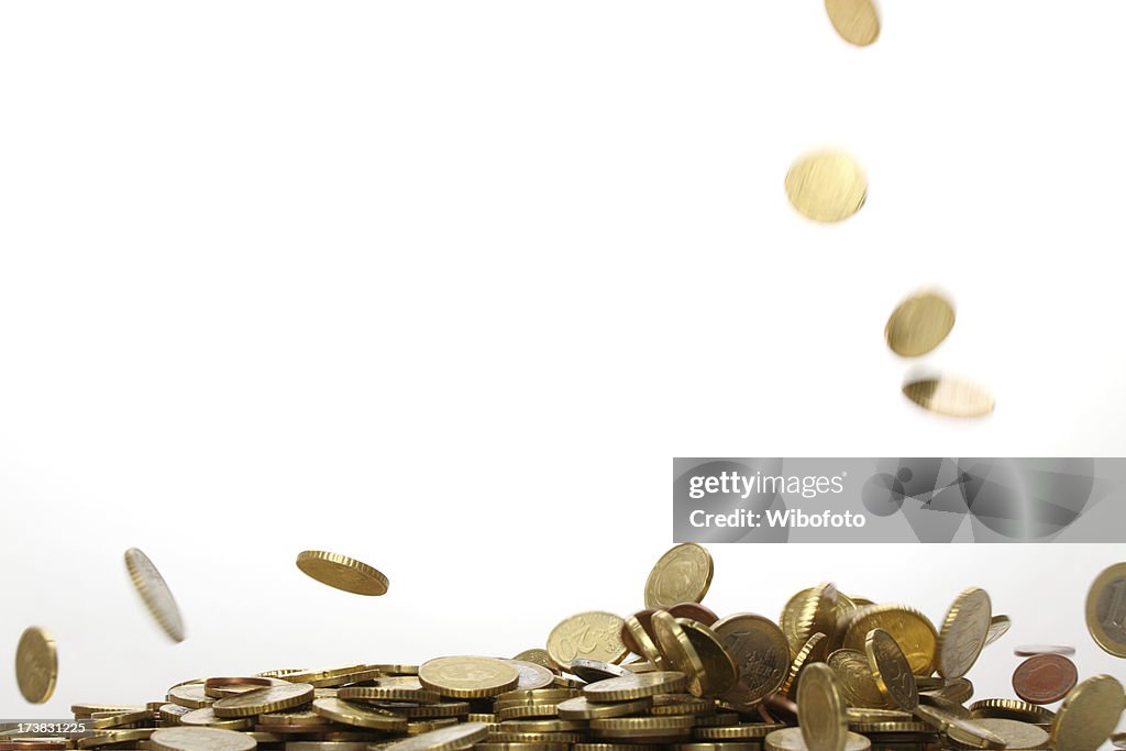 Gold euro coins falling and forming a pile 