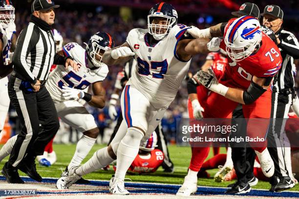 Dexter Lawrence II of the New York Giants grabs Spencer Brown of the Buffalo Bills as a fight that breaks out during the game at Highmark Stadium on...