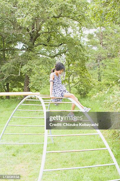 girl in the park - climbing frame stock pictures, royalty-free photos & images