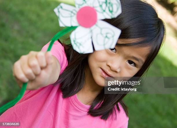 chinese girl holding homemade flower - giving a girl head stock pictures, royalty-free photos & images