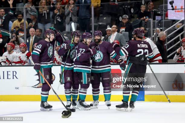 Frank Vatrano of the Anaheim Ducks celebrates a hat trick with teammates Jackson LaCombe, Ryan Strome, Radko Gudas and Mason McTavish during the game...