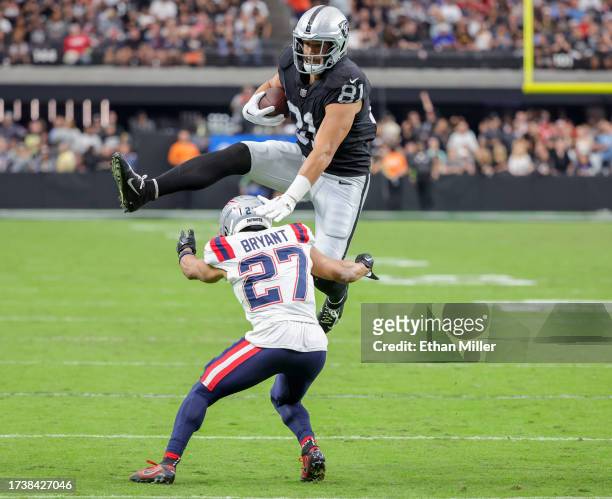 Tight end Austin Hooper of the Las Vegas Raiders hurdles cornerback Myles Bryant of the New England Patriots in the fourth quarter of their game at...