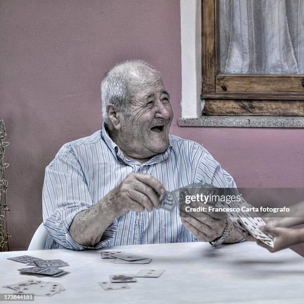 old man playing cards. - sardinien stock-fotos und bilder