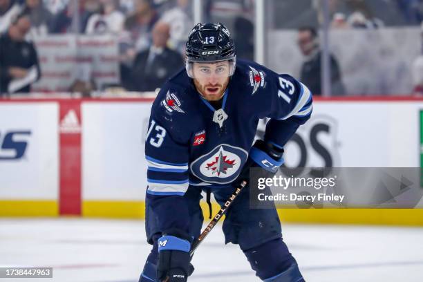 Gabriel Vilardi of the Winnipeg Jets gets set during a first period face-off against the Florida Panthers at the Canada Life Centre on October 14,...
