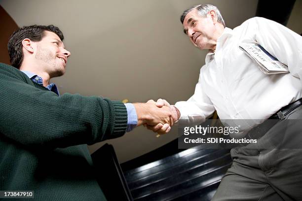 two business men meeting and shaking hands - christianity stock pictures, royalty-free photos & images