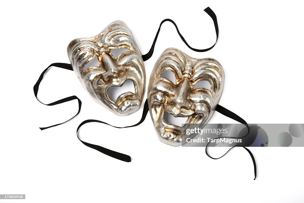Silver and gold Comedy and Tragedy theater masks on white