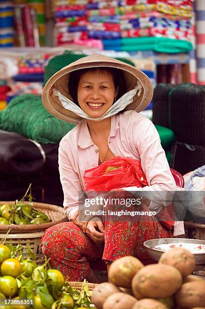 photo of vietnamese woman selling vegetables at market - vietnam market stock pictures, royalty-free photos & images
