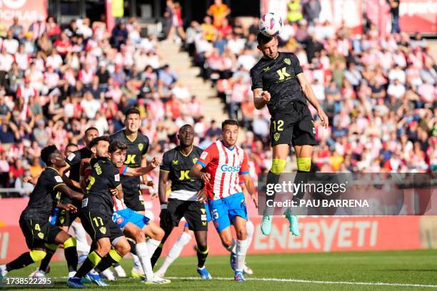 Almeria's Brazilian forward Leo Baptistao heads the ball during the Spanish league football match between Girona FC and UD Almeria at the Montilivi...