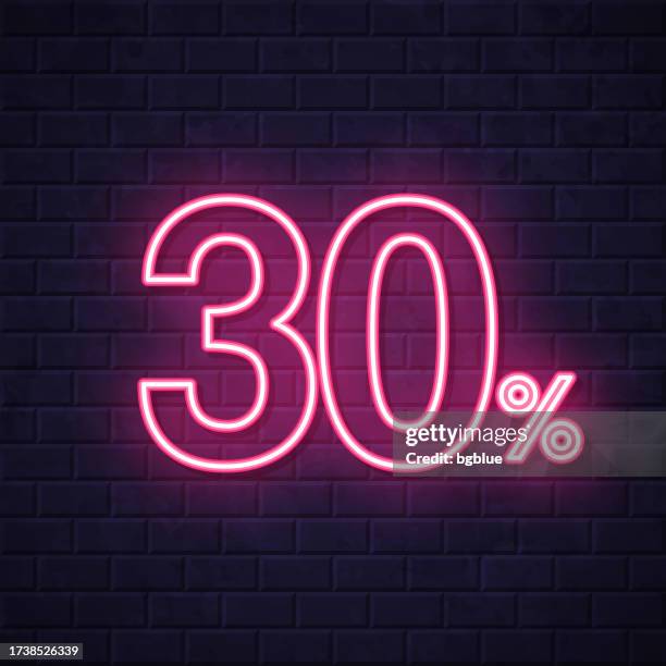 30% - thirty percent. glowing neon icon on brick wall background - fee reduction stock illustrations