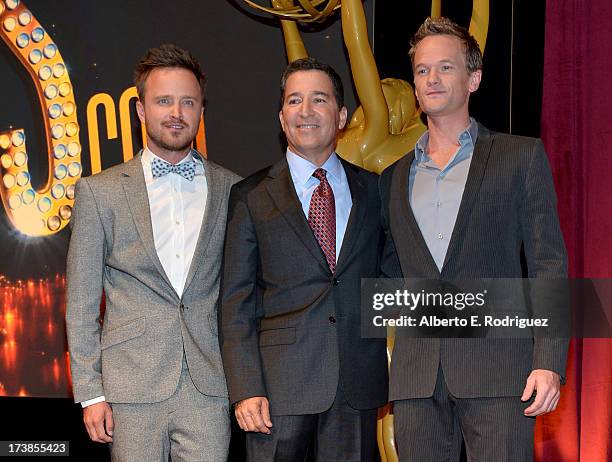 Actor Aaron Paul, Academy of Television Arts & Sciences Chairman & CEO Bruce Rosenblum and actor Neil Patrick Harris pose onstage following the 65th...