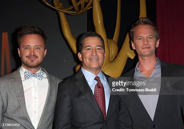 Actors Aaron Paul and Neil Patrick Harris , and Academy of Television Arts & Sciences Chairman & CEO Bruce Rosenblum pose onstage during the 65th...