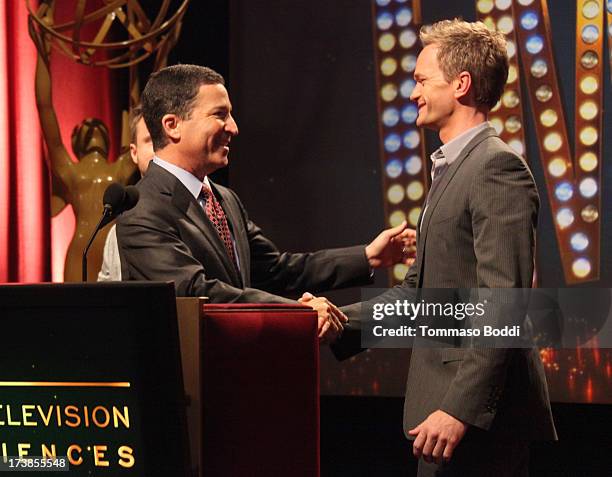 Acto Neil Patrick Harris walks onstage to join Academy of Television Arts & Sciences Chairman & CEO Bruce Rosenblum during the 65th Primetime Emmy...