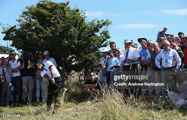 Tiger Woods of the United States hits out of the rough on the 1st hole during the first round of the 142nd Open Championship at Muirfield on July 18,...