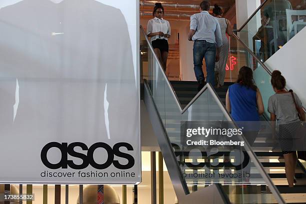 Visitors walk up stairs in the reception area at the headquarters of Asos Plc in London, U.K., on Wednesday, July 17, 2013. Asos Plc, the U.K.'s...