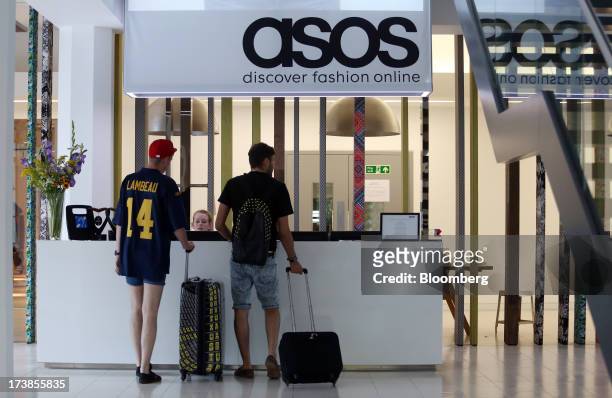 Visitors stand in the reception area at the headquarters of Asos Plc in London, U.K., on Wednesday, July 17, 2013. Asos Plc, the U.K.'s largest...