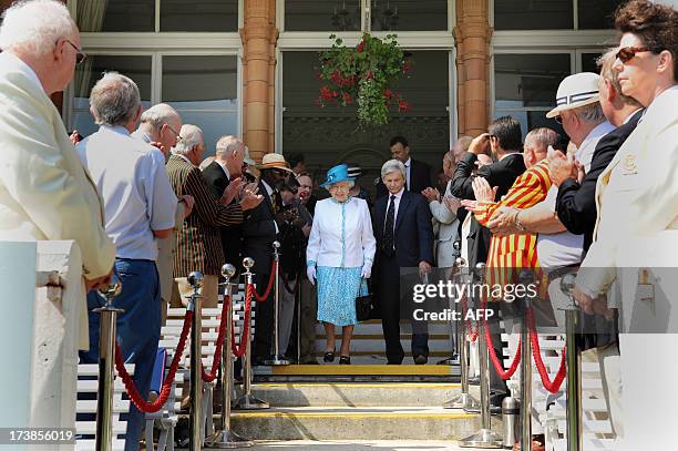 Britain's Queen Elizabeth II walks down the steps of the Pavilion at Lord's Cricket Ground on the first day of the second Ashes cricket test match...