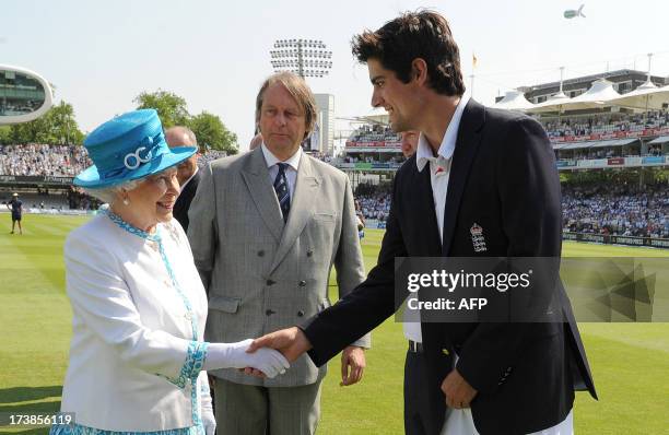 Britain's Queen Elizabeth II shakes hands with England captain Alastair Cook as ECB Chairman Giles Clarke looks on during the first day of the second...