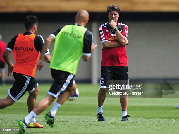 Swansea City manager Michael Laudrup looks on during training at Landore training complex on July 18, 2013 in Swansea, Wales.