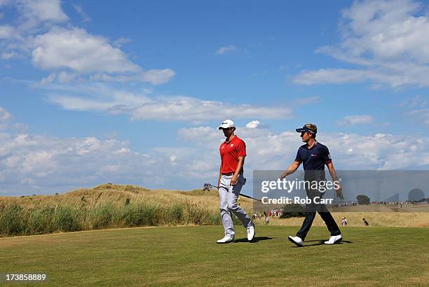 Adam Scott of Australia and Luke Donald of England walk to the 5th hole during the first round of the 142nd Open Championship at Muirfield on July...